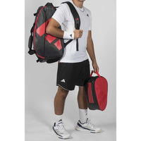 A man wearing Adidas multigame black red padel bag 2026 in Pakistan